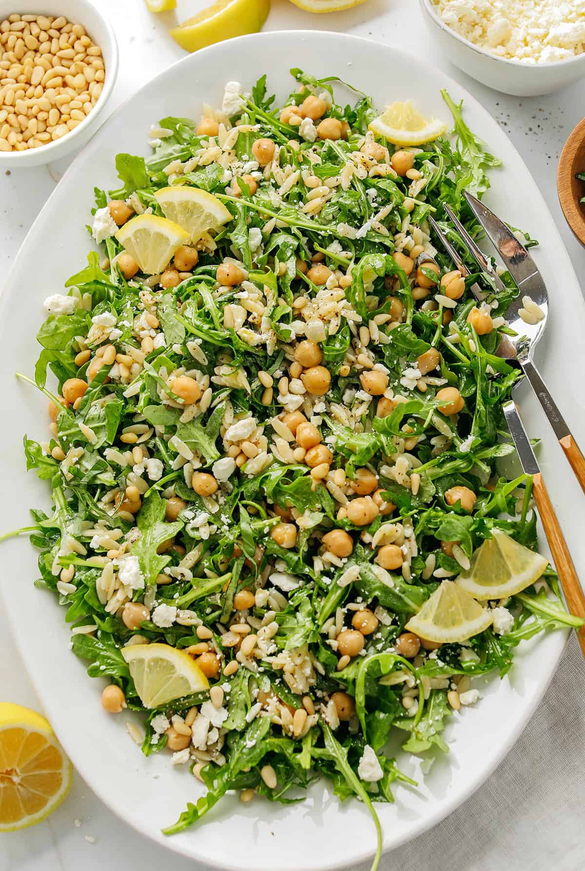 This Lemon Arugula Orzo Salad is a bright, zesty pasta salad packed with fresh greens, tender orzo, protein-packed chickpeas, crumbled feta cheese and a simple lemon dressing. Perfect for spring and summer meals!
