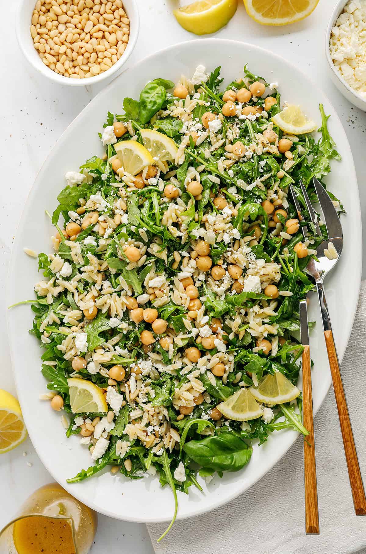 This Lemon Arugula Orzo Salad is a bright, zesty pasta salad packed with fresh greens, tender orzo, protein-packed chickpeas, crumbled feta cheese and a simple lemon dressing. Perfect for spring and summer meals!