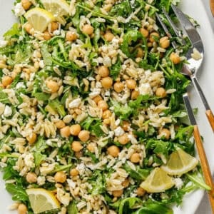 This Lemon Arugula Orzo Salad is a bright, zesty pasta salad packed with fresh greens, tender orzo, protein-packed chickpeas, crumbled feta cheese and a simple lemon dressing. Perfect for spring and summer meals!
