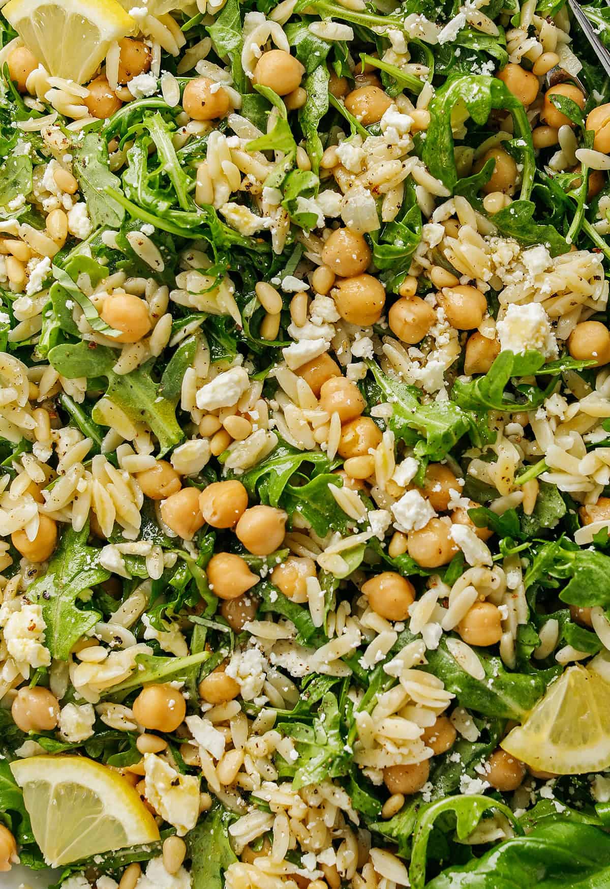 This Lemon Arugula Orzo Salad is a bright, zesty pasta salad packed with fresh greens, tender orzo, protein-packed chickpeas, crumbled feta cheese and a simple lemon dressing. Perfect for spring and summer meals!