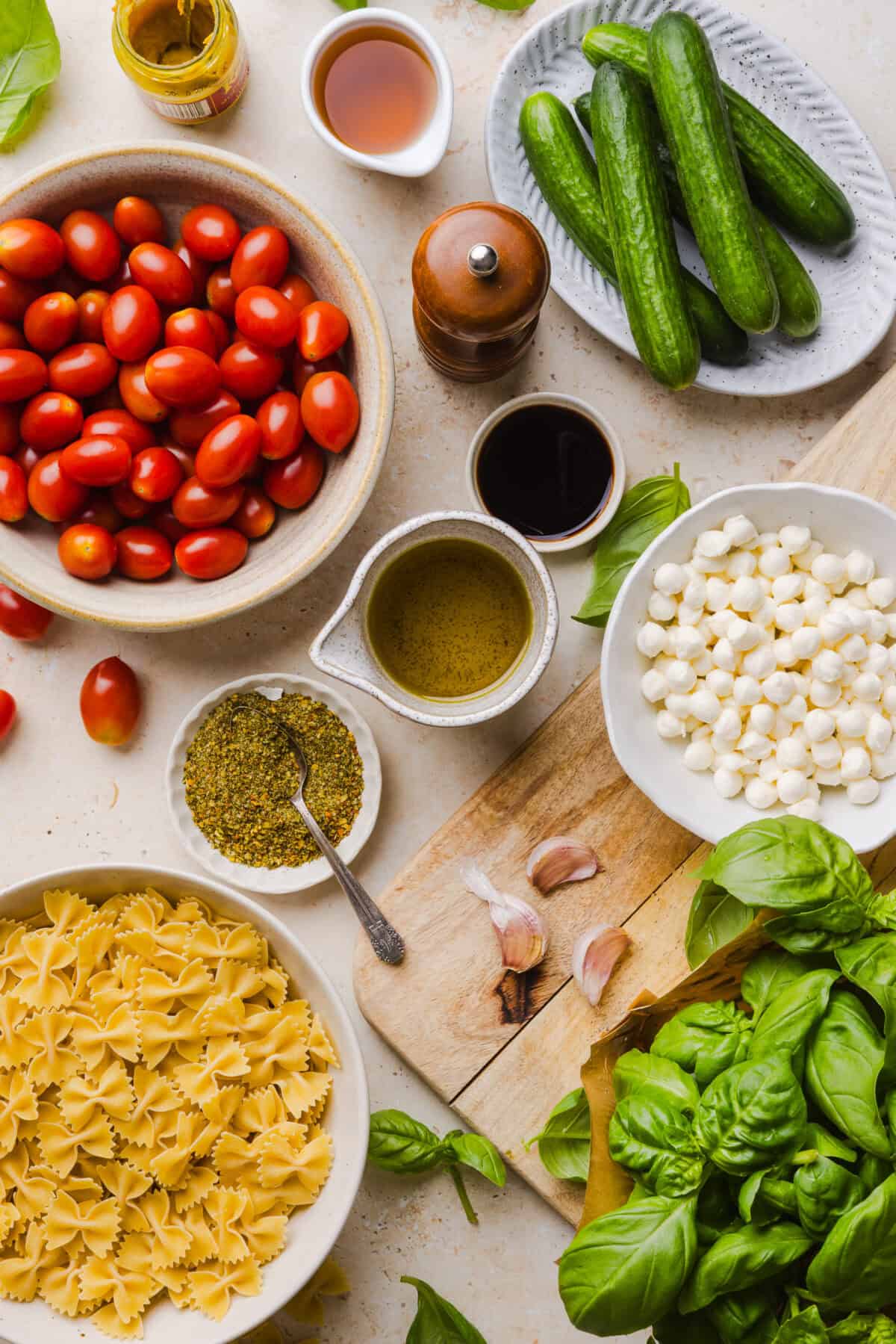 This Easy Caprese Pasta Salad is loaded with fresh tomatoes, mozzarella pearls, fresh basil, cucumbers, and a delicious homemade herb vinaigrette. The perfect make-ahead summer side dish for BBQs, lunches and meal prep!