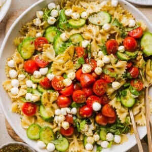 This Easy Caprese Pasta Salad is loaded with fresh tomatoes, mozzarella pearls, fresh basil, cucumbers, and a delicious homemade herb vinaigrette. The perfect make-ahead summer side dish for BBQs, lunches and meal prep!