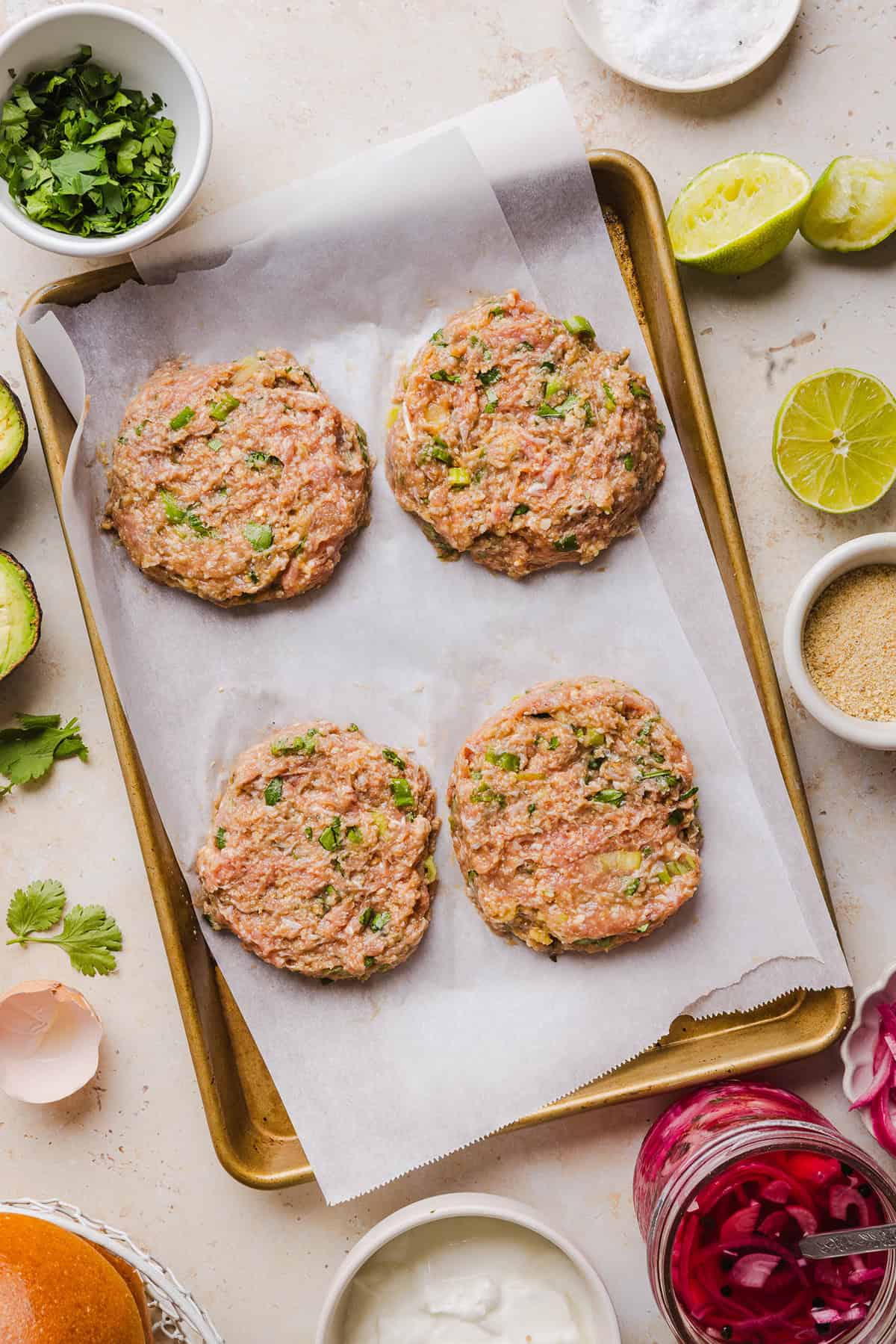 These Cilantro Lime Chicken Burgers are juicy, flavorful, and topped with a creamy avocado cilantro sauce. Made with lean ground chicken, fresh cilantro, green onions, and lime zest, these burgers are perfect for summer grilling or an easy weeknight meal!