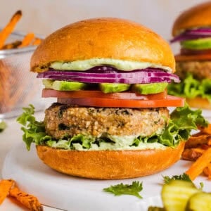 These Cilantro Lime Chicken Burgers are juicy, flavorful, and topped with a creamy avocado cilantro sauce. Made with lean ground chicken, fresh cilantro, green onions, and lime zest, these burgers are perfect for summer grilling or an easy weeknight meal!