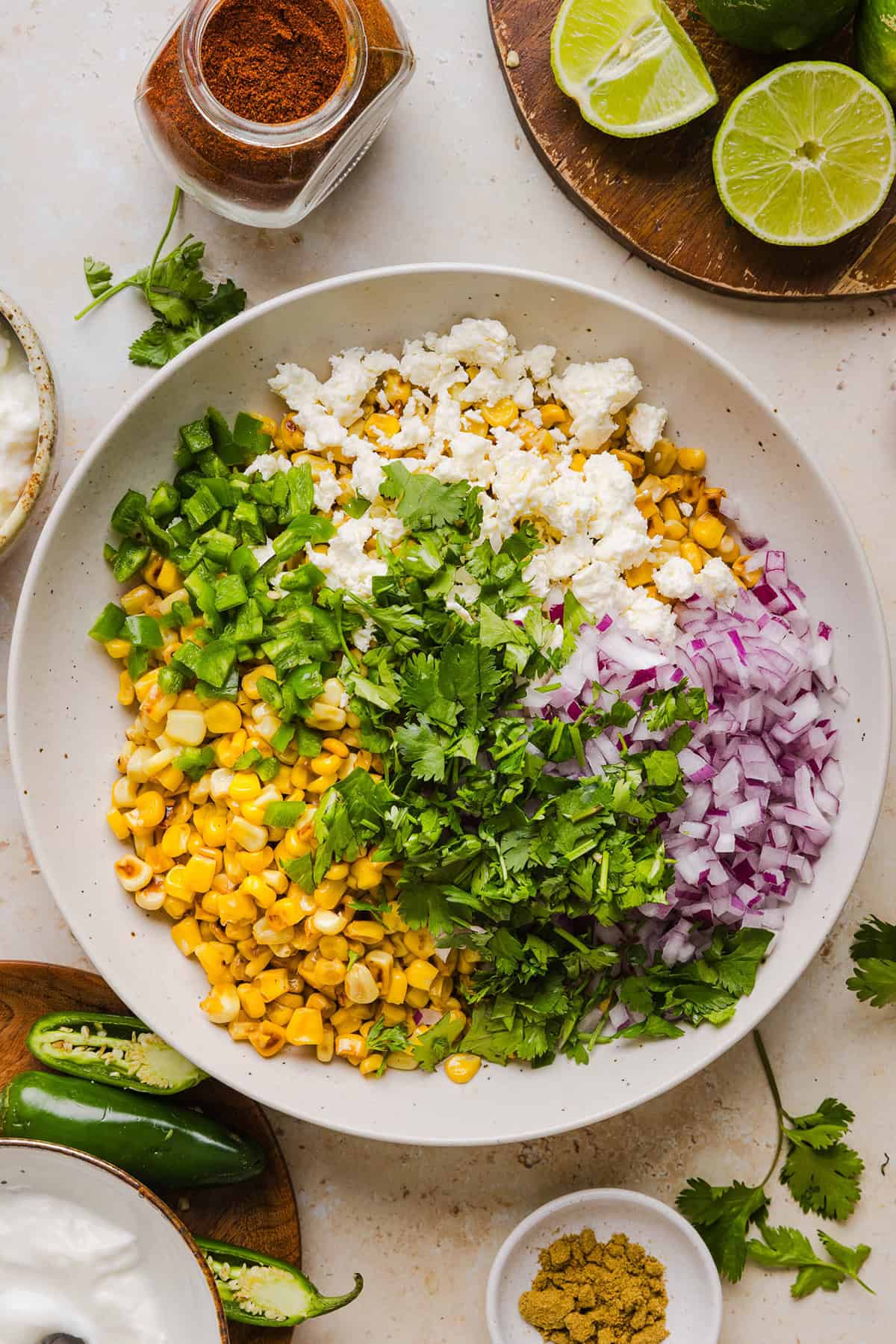 This Healthy Mexican Street Corn Salad is a fresh and flavorful summer side dish loaded with sweet grilled corn, cotija cheese, cilantro, jalapeño, and a creamy protein-packed lime dressing. Perfect for cookouts, taco nights and meal prep!
