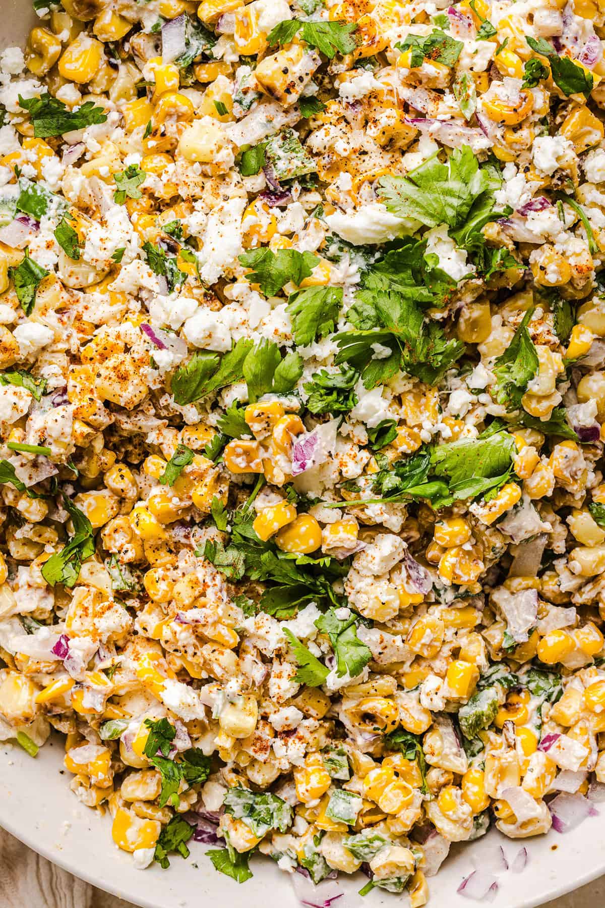This Healthy Mexican Street Corn Salad is a fresh and flavorful summer side dish loaded with sweet grilled corn, cotija cheese, cilantro, jalapeño, and a creamy protein-packed lime dressing. Perfect for cookouts, taco nights and meal prep!