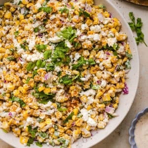 This Healthy Mexican Street Corn Salad is a fresh and flavorful summer side dish loaded with sweet grilled corn, cotija cheese, cilantro, jalapeño, and a creamy protein-packed lime dressing. Perfect for cookouts, taco nights and meal prep!