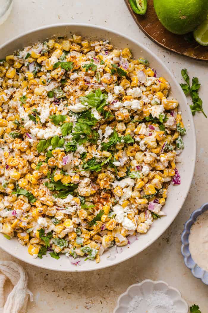 This Healthy Mexican Street Corn Salad is a fresh and flavorful summer side dish loaded with sweet grilled corn, cotija cheese, cilantro, jalapeño, and a creamy protein-packed lime dressing. Perfect for cookouts, taco nights and meal prep!