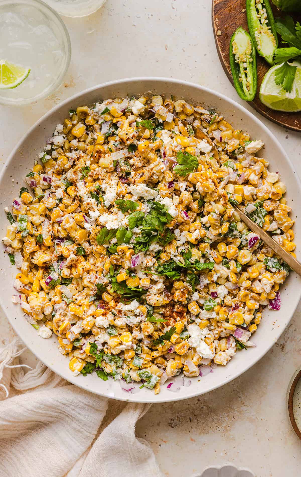 This Healthy Mexican Street Corn Salad is a fresh and flavorful summer side dish loaded with sweet grilled corn, cotija cheese, cilantro, jalapeño, and a creamy protein-packed lime dressing. Perfect for cookouts, taco nights and meal prep!