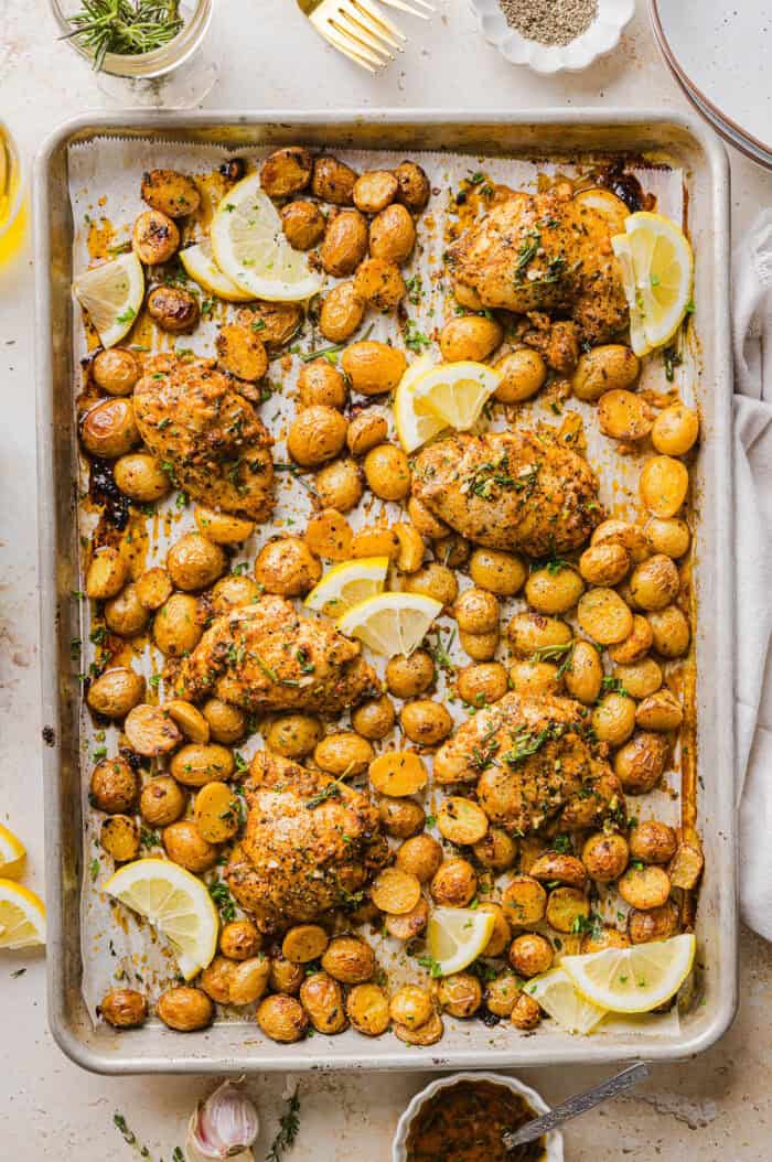 Make dinner easy with this Sheet Pan Lemon Herb Chicken and Potatoes recipe! Tender lemon rosemary chicken thighs and crispy roasted potatoes come together on one pan for a flavorful, family-friendly meal with minimal cleanup.