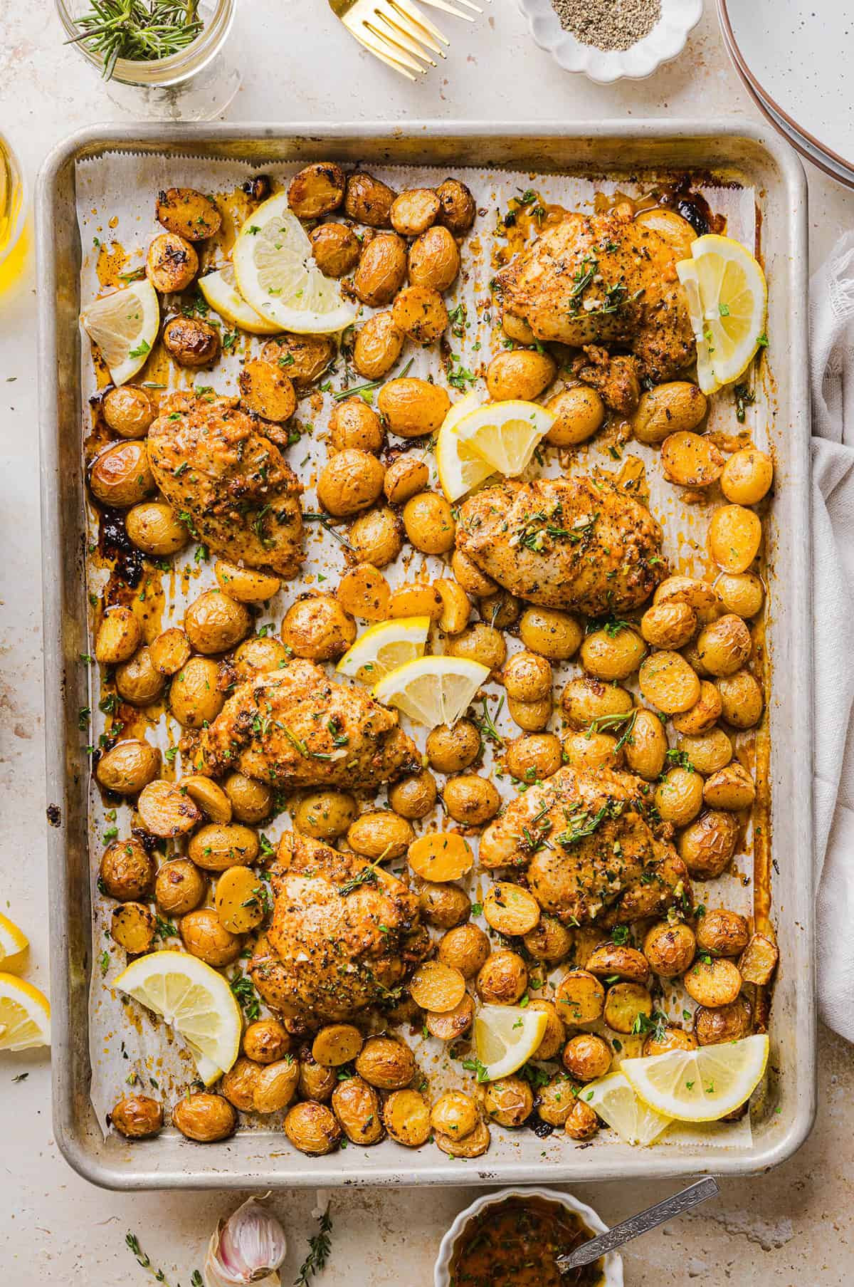 Make dinner easy with this Sheet Pan Lemon Herb Chicken and Potatoes recipe! Tender lemon rosemary chicken thighs and crispy roasted potatoes come together on one pan for a flavorful, family-friendly meal with minimal cleanup.