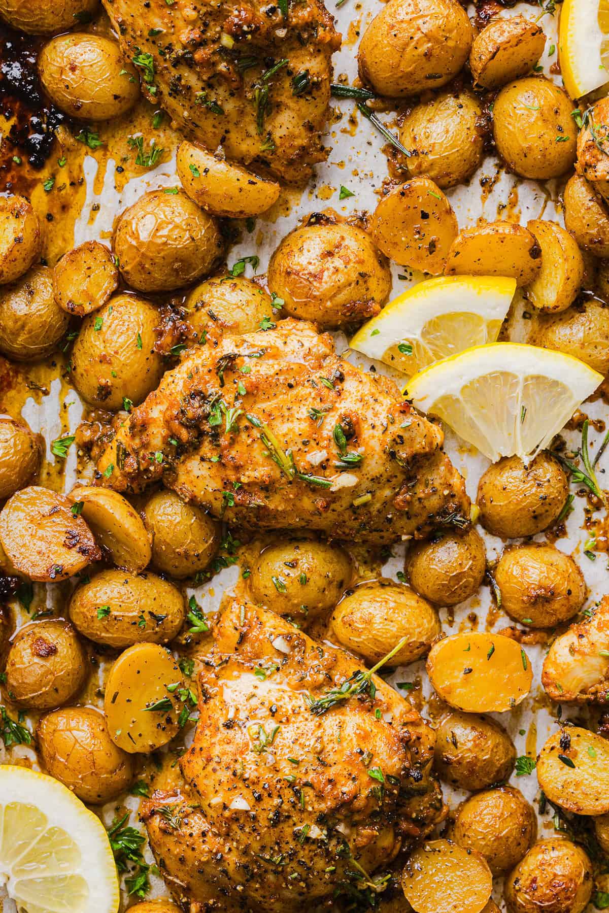 Make dinner easy with this Sheet Pan Lemon Herb Chicken and Potatoes recipe! Tender lemon rosemary chicken thighs and crispy roasted potatoes come together on one pan for a flavorful, family-friendly meal with minimal cleanup.