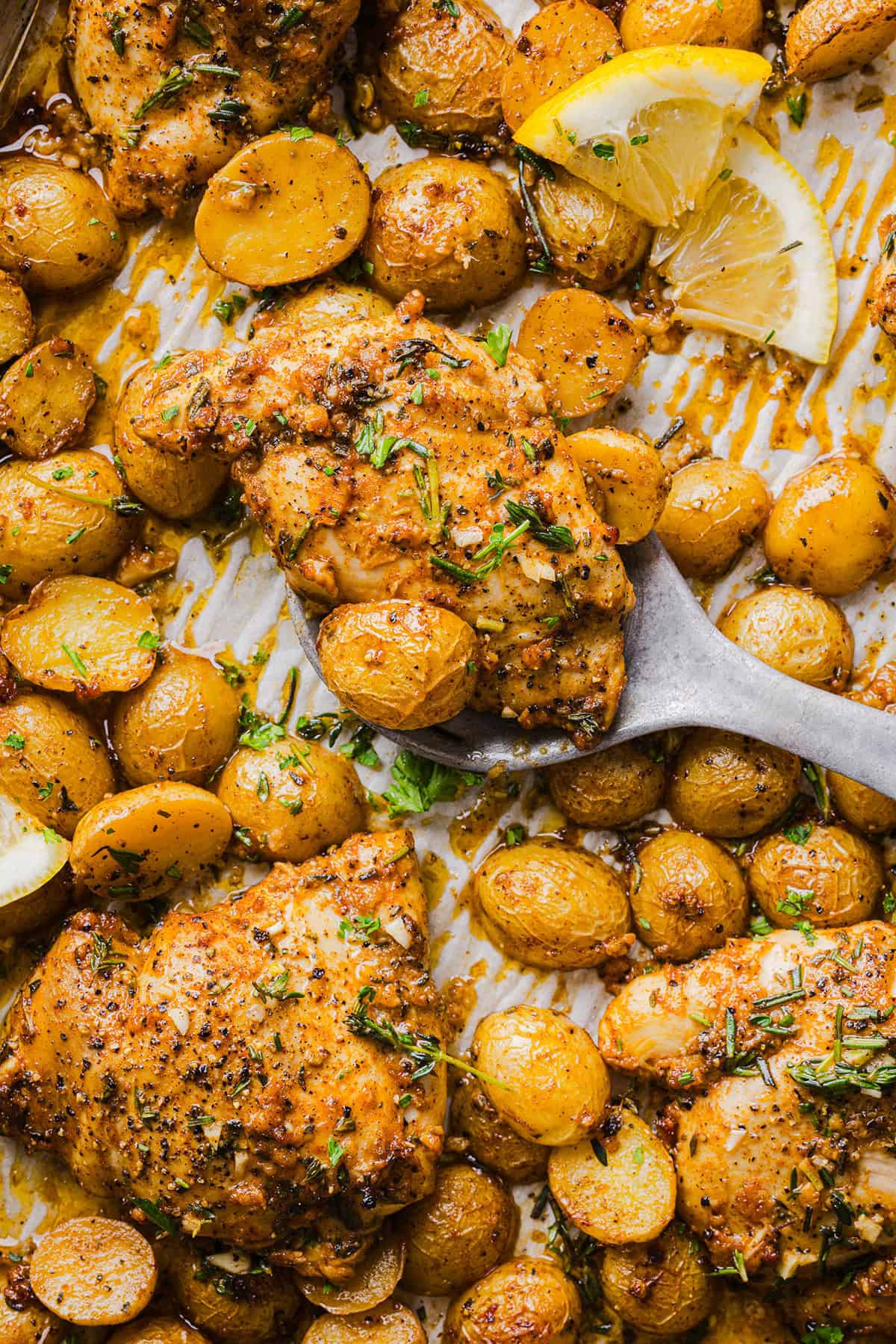 Make dinner easy with this Sheet Pan Lemon Herb Chicken and Potatoes recipe! Tender lemon rosemary chicken thighs and crispy roasted potatoes come together on one pan for a flavorful, family-friendly meal with minimal cleanup.