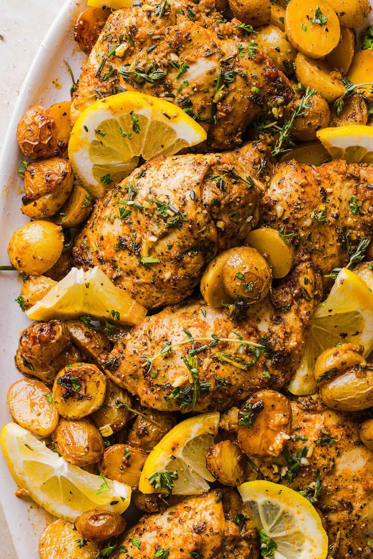 Make dinner easy with this Sheet Pan Lemon Herb Chicken and Potatoes recipe! Tender lemon rosemary chicken thighs and crispy roasted potatoes come together on one pan for a flavorful, family-friendly meal with minimal cleanup.