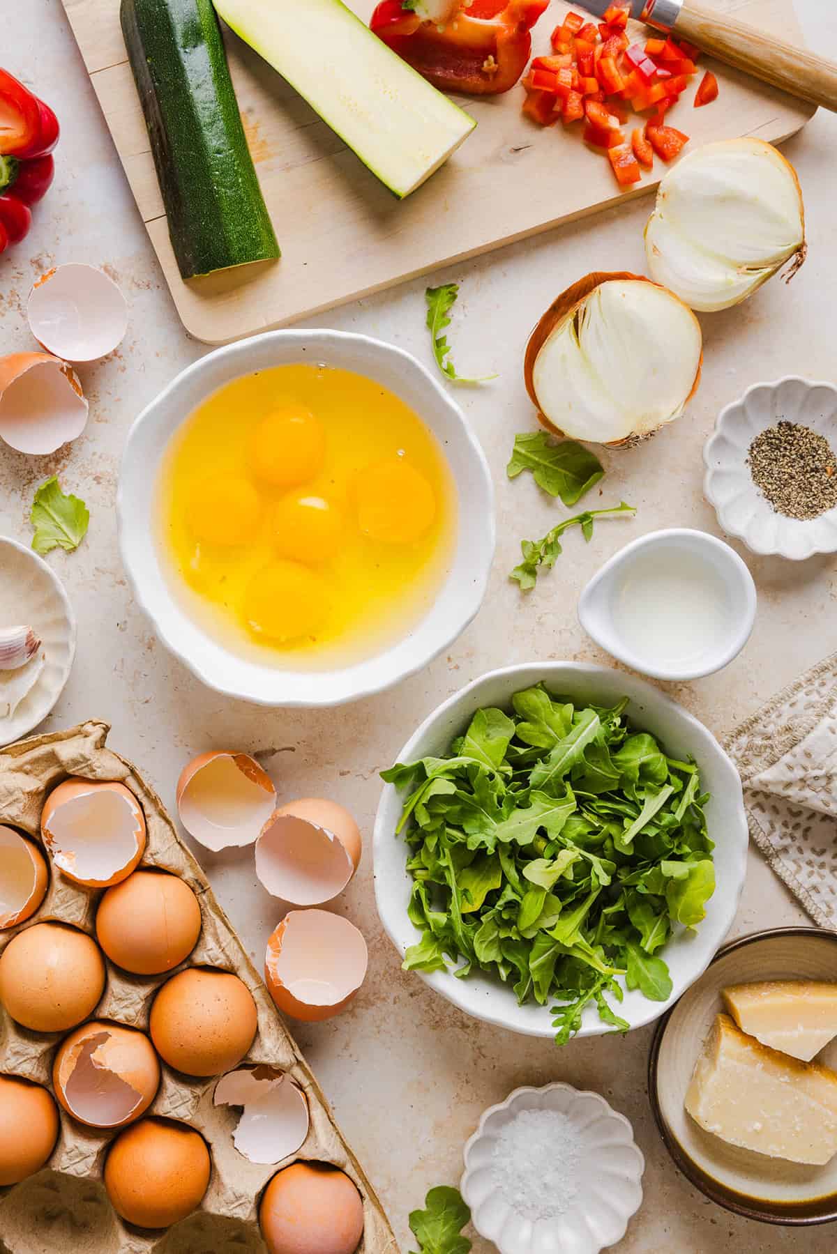 These Healthy Veggie Egg Muffins are an easy, protein-packed breakfast made with eggs, zucchini, bell peppers, onion, arugula and parmesan cheese. These healthy egg muffins are fluffy, flavorful and perfect for meal prep and busy mornings!
