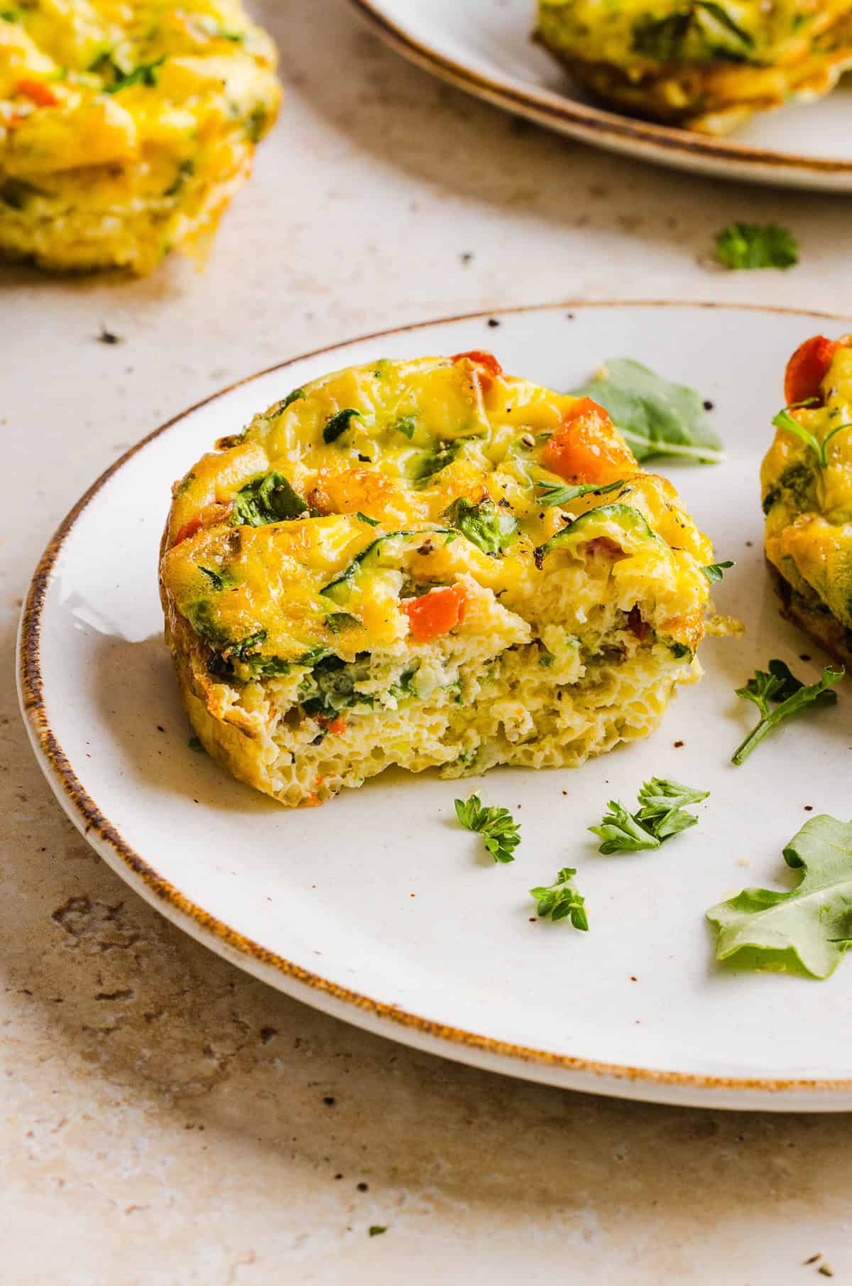 These Healthy Veggie Egg Muffins are an easy, protein-packed breakfast made with eggs, zucchini, bell peppers, onion, arugula and parmesan cheese. These healthy egg muffins are fluffy, flavorful and perfect for meal prep and busy mornings!