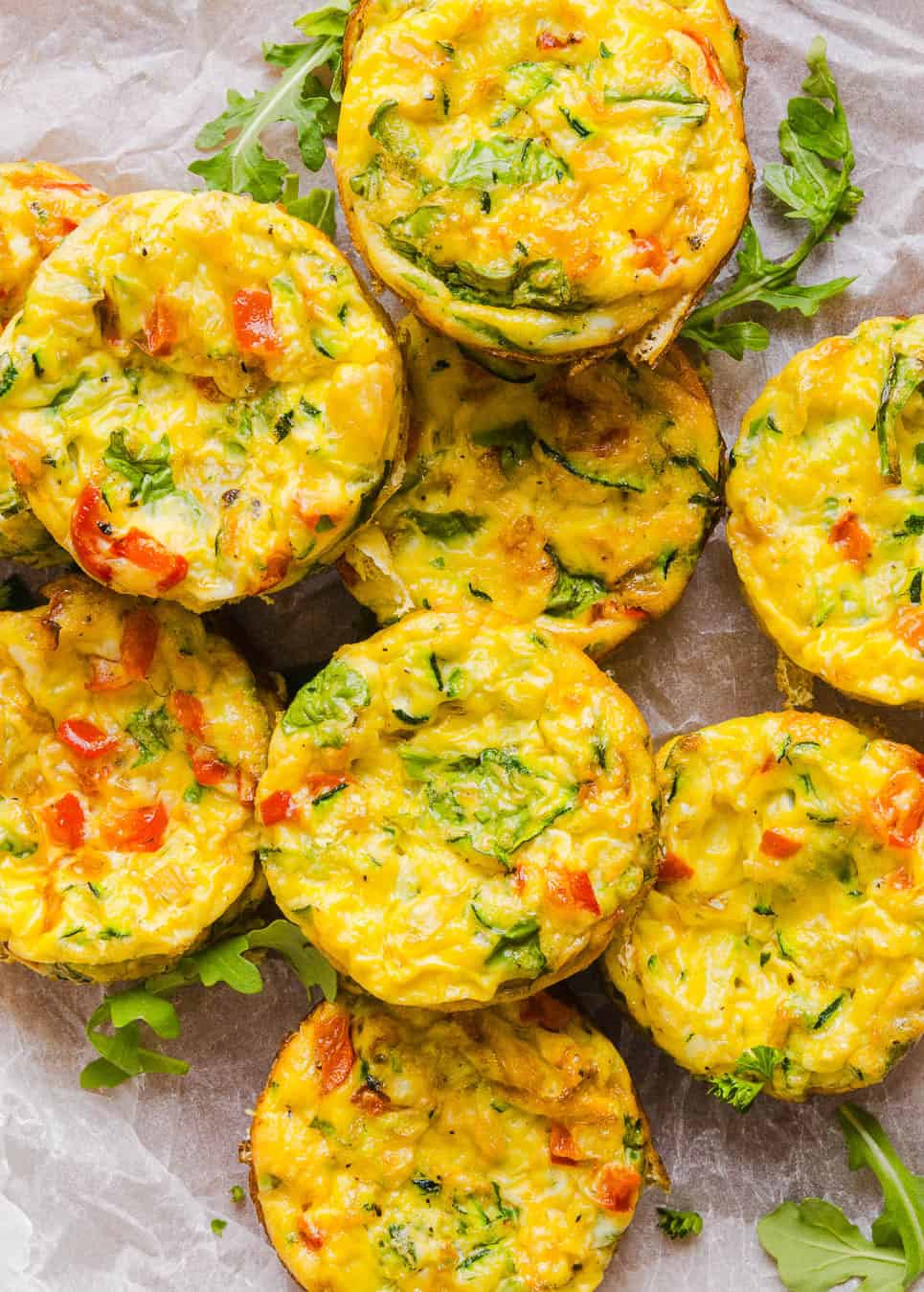 These Healthy Veggie Egg Muffins are an easy, protein-packed breakfast made with eggs, zucchini, bell peppers, onion, arugula and parmesan cheese. These healthy egg muffins are fluffy, flavorful and perfect for meal prep and busy mornings!