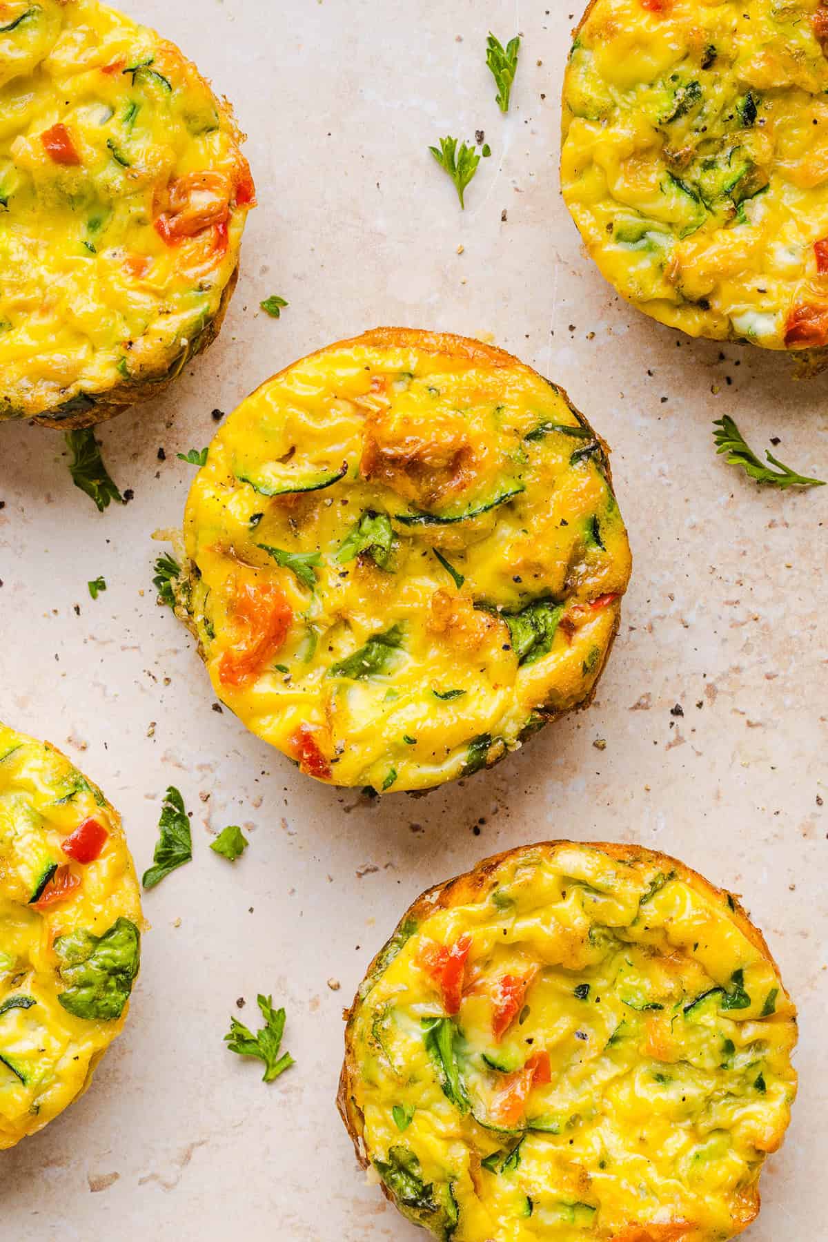 These Healthy Veggie Egg Muffins are an easy, protein-packed breakfast made with eggs, zucchini, bell peppers, onion, arugula and parmesan cheese. These healthy egg muffins are fluffy, flavorful and perfect for meal prep and busy mornings!