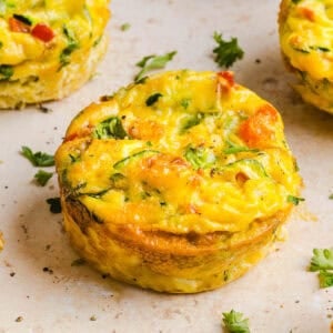 These Healthy Veggie Egg Muffins are an easy, protein-packed breakfast made with eggs, zucchini, bell peppers, onion, arugula and parmesan cheese. These healthy egg muffins are fluffy, flavorful and perfect for meal prep and busy mornings!