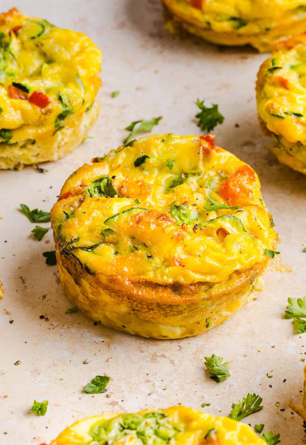 These Healthy Veggie Egg Muffins are an easy, protein-packed breakfast made with eggs, zucchini, bell peppers, onion, arugula and parmesan cheese. These healthy egg muffins are fluffy, flavorful and perfect for meal prep and busy mornings!