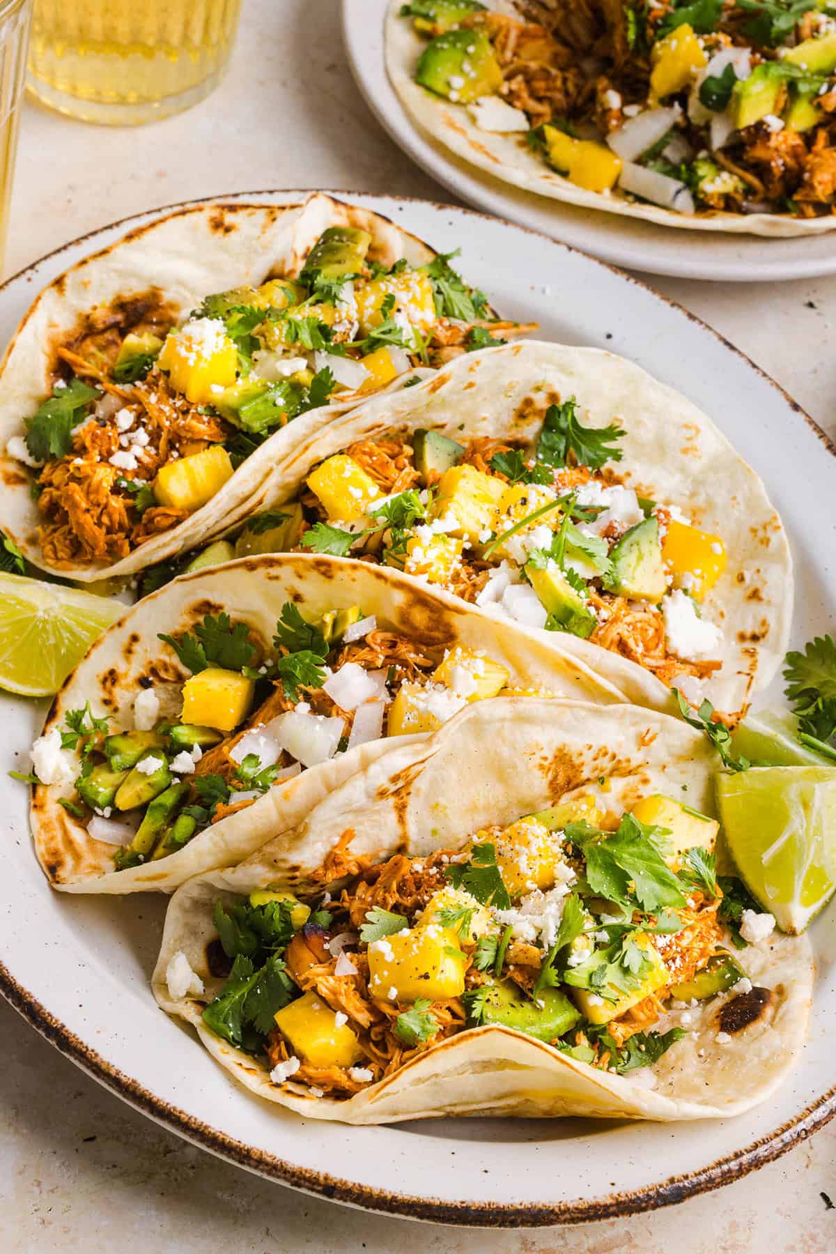These Crock Pot Chicken Al Pastor Tacos are sweet, smoky, and incredibly flavorful! An easy slow cooker dinner made with juicy shredded chicken, fresh pineapple, chipotle peppers, and warm spices for a healthy, protein-packed dinner.