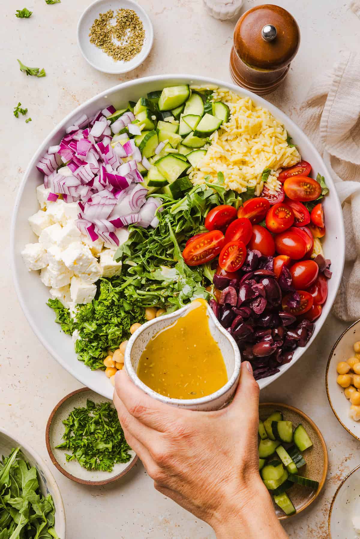 This Easy Greek Orzo Salad is packed with fresh veggies, chickpeas, feta, and the most delicious homemade lemon herb dressing. Perfect for meal prep, picnics, and summer cookouts!