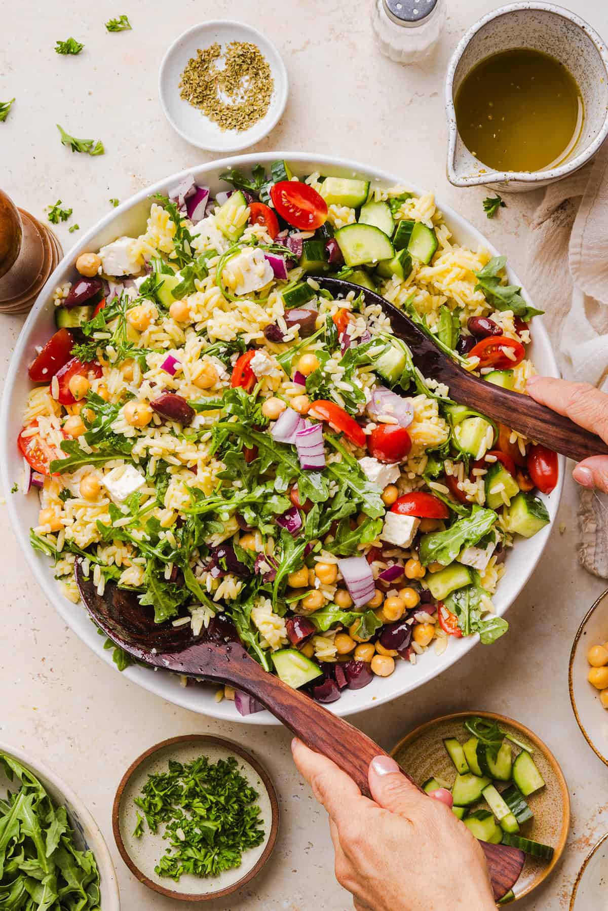 This Easy Greek Orzo Salad is packed with fresh veggies, chickpeas, feta, and the most delicious homemade lemon herb dressing. Perfect for meal prep, picnics, and summer cookouts!