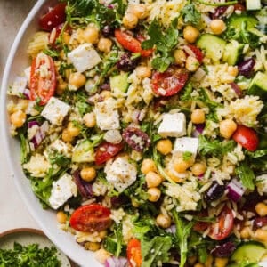This Easy Greek Orzo Salad is packed with fresh veggies, chickpeas, feta, and the most delicious homemade lemon herb dressing. Perfect for meal prep, picnics, and summer cookouts!