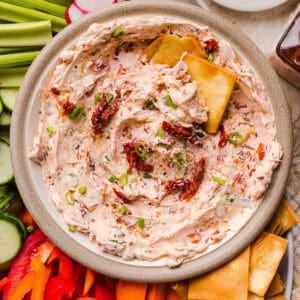 The BEST Creamy Sun-Dried Tomato Dip recipe made with protein-packed Greek yogurt, cream cheese, garlic, and bell peppers. Easy to make, perfect for parties, and ready in just minutes!