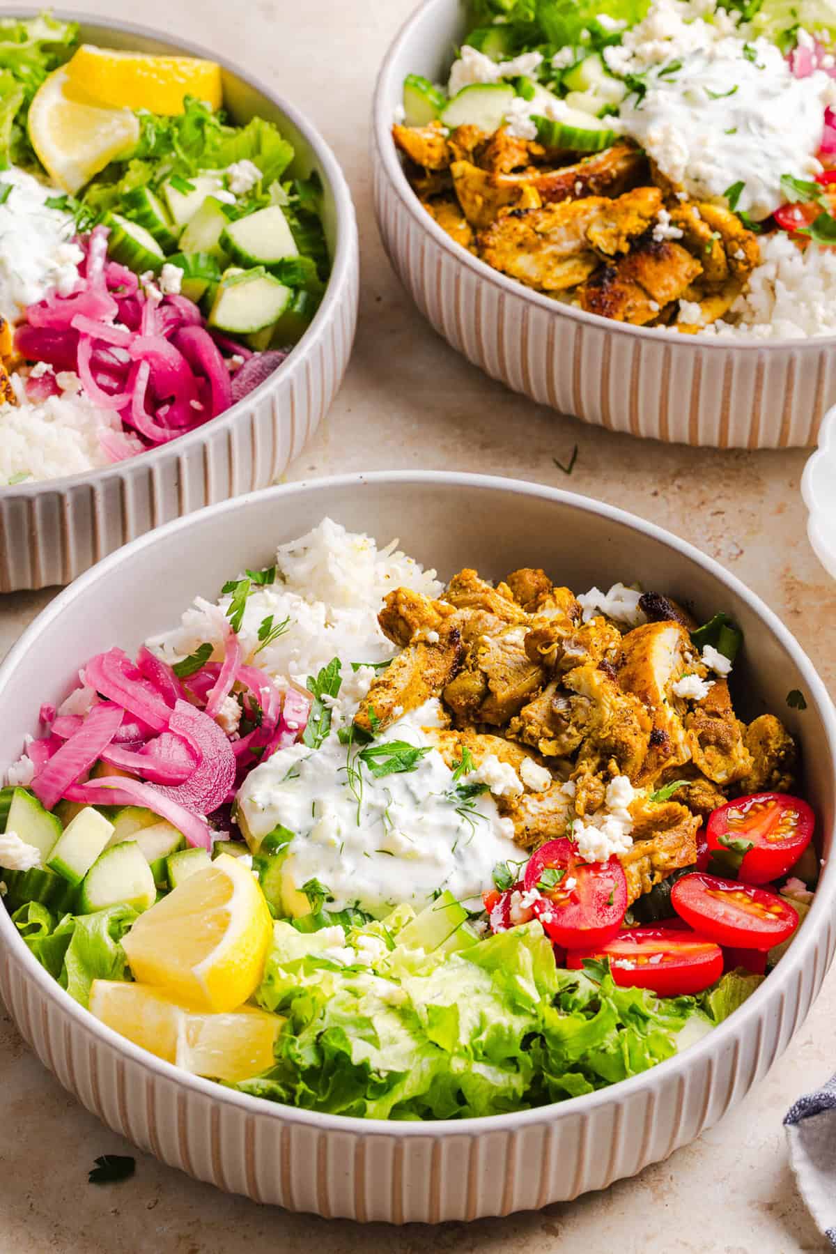 These Easy Chicken Shawarma Bowls are loaded with juicy spiced chicken, fluffy rice, fresh veggies, feta and creamy homemade tzatziki! A healthy, flavor-packed meal that is great for meal prep!