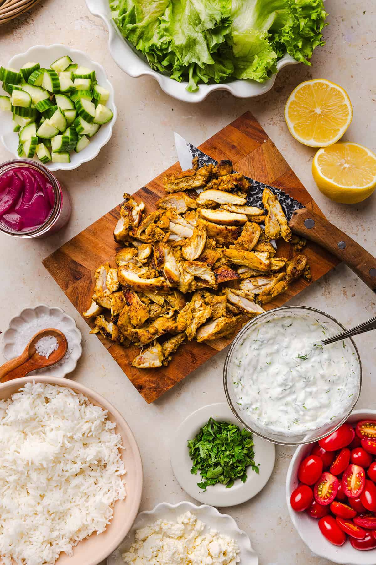 These Easy Chicken Shawarma Bowls are loaded with juicy spiced chicken, fluffy rice, fresh veggies, feta and creamy homemade tzatziki! A healthy, flavor-packed meal that is great for meal prep!