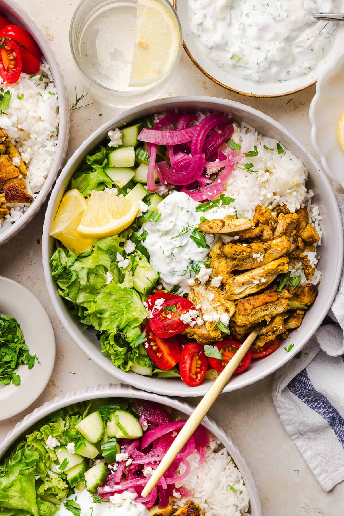 These Easy Chicken Shawarma Bowls are loaded with juicy spiced chicken, fluffy rice, fresh veggies, feta and creamy homemade tzatziki! A healthy, flavor-packed meal that is great for meal prep!
