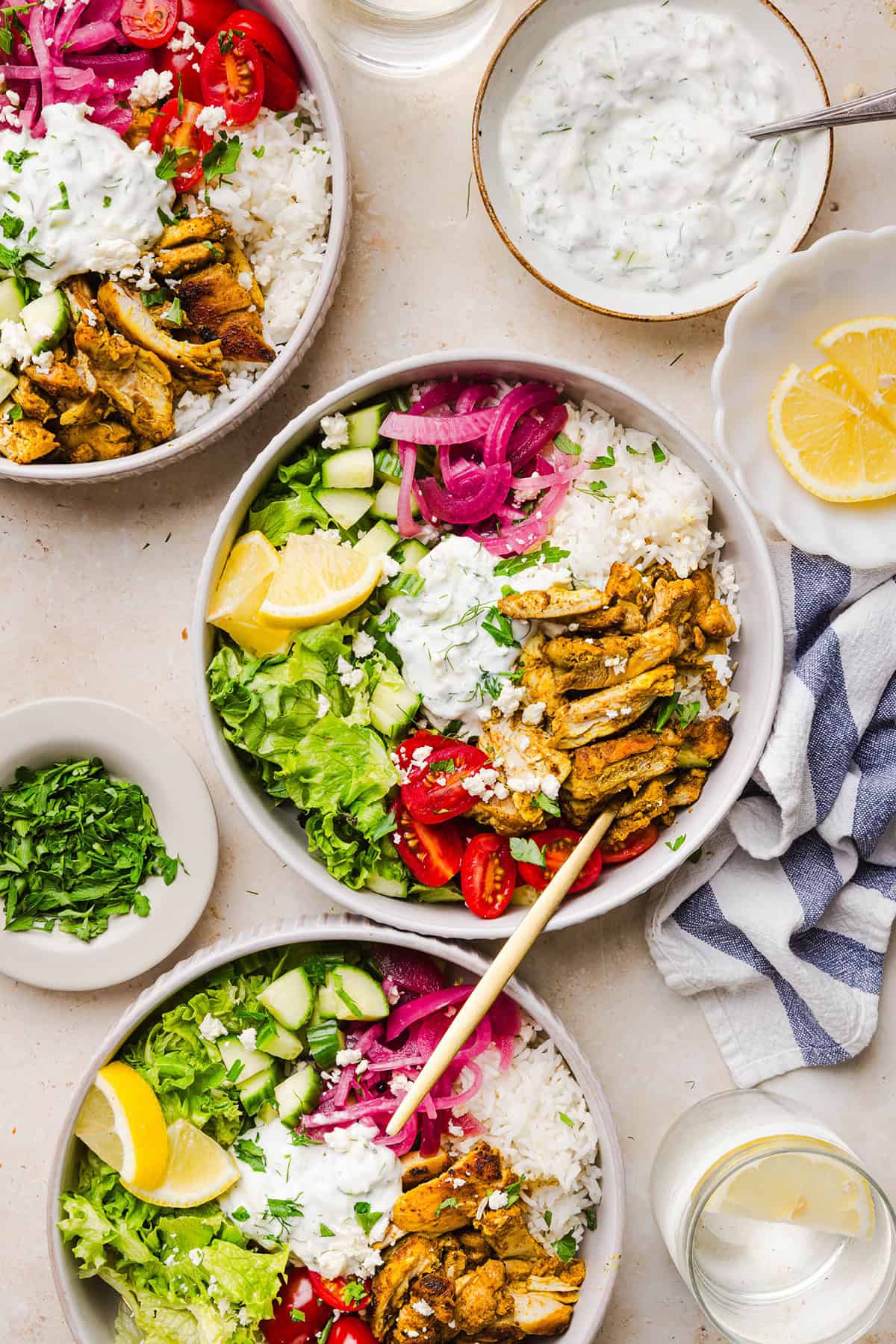 These Easy Chicken Shawarma Bowls are loaded with juicy spiced chicken, fluffy rice, fresh veggies, feta and creamy homemade tzatziki! A healthy, flavor-packed meal that is great for meal prep!