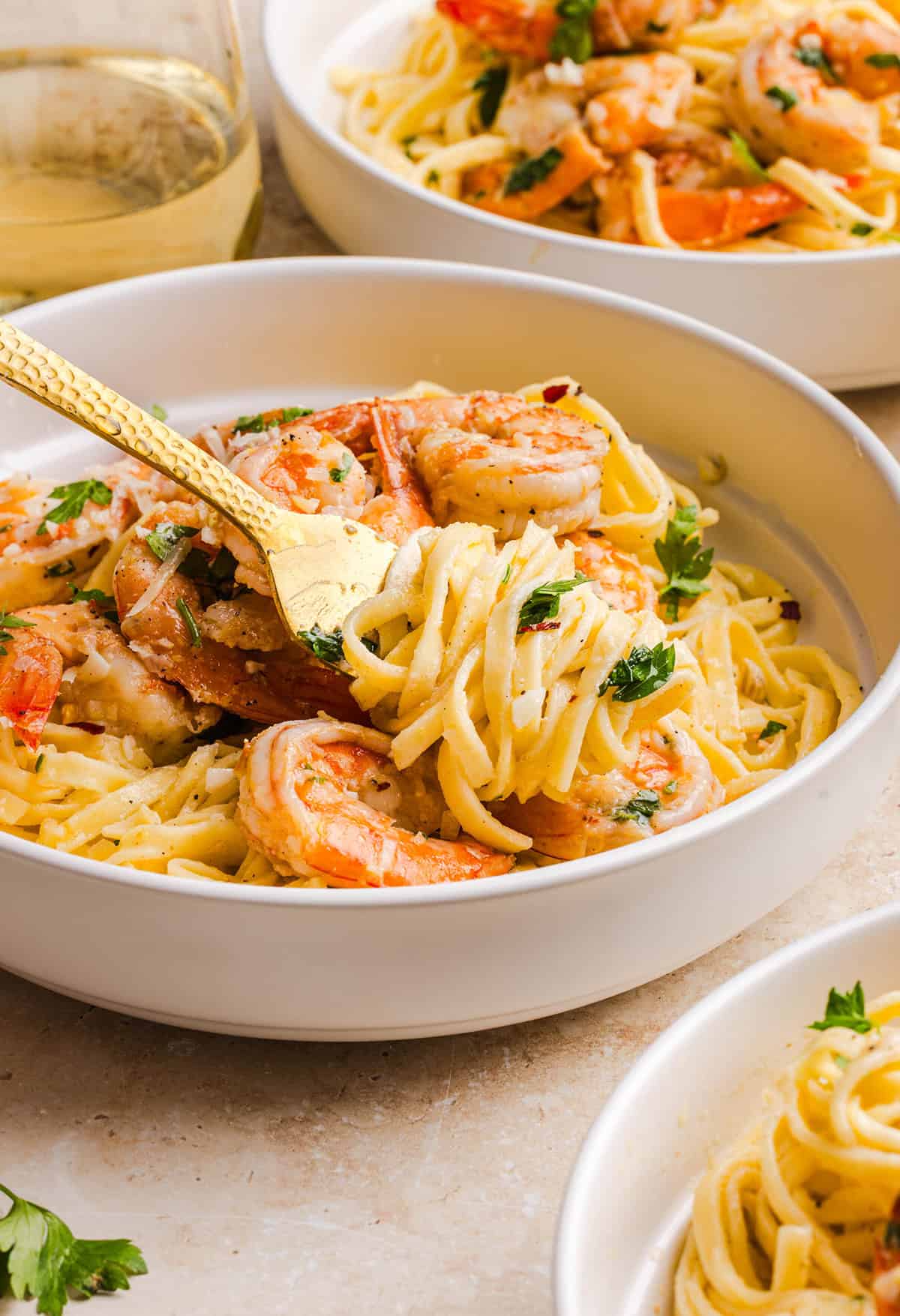 The BEST Healthy Shrimp Scampi recipe lightened up without sacrificing flavor! Juicy shrimp, garlic, lemon, white wine, and Parmesan are tossed with tender linguine in a silky, buttery sauce that’s ready in just 30 minutes.