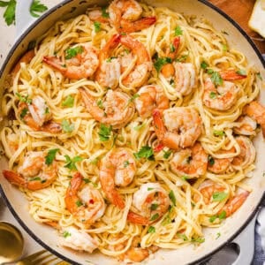 The BEST Healthy Shrimp Scampi recipe lightened up without sacrificing flavor! Juicy shrimp, garlic, lemon, white wine, and Parmesan are tossed with tender linguine in a silky, buttery sauce that’s ready in just 30 minutes.