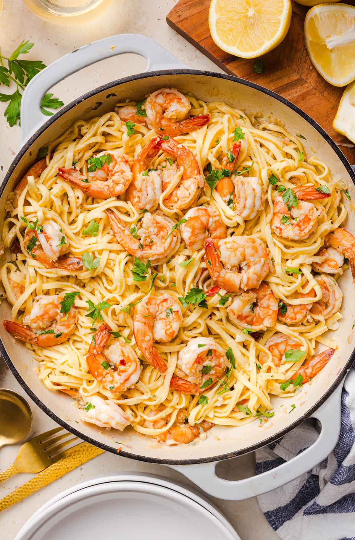 The BEST Healthy Shrimp Scampi recipe lightened up without sacrificing flavor! Juicy shrimp, garlic, lemon, white wine, and Parmesan are tossed with tender linguine in a silky, buttery sauce that’s ready in just 30 minutes.