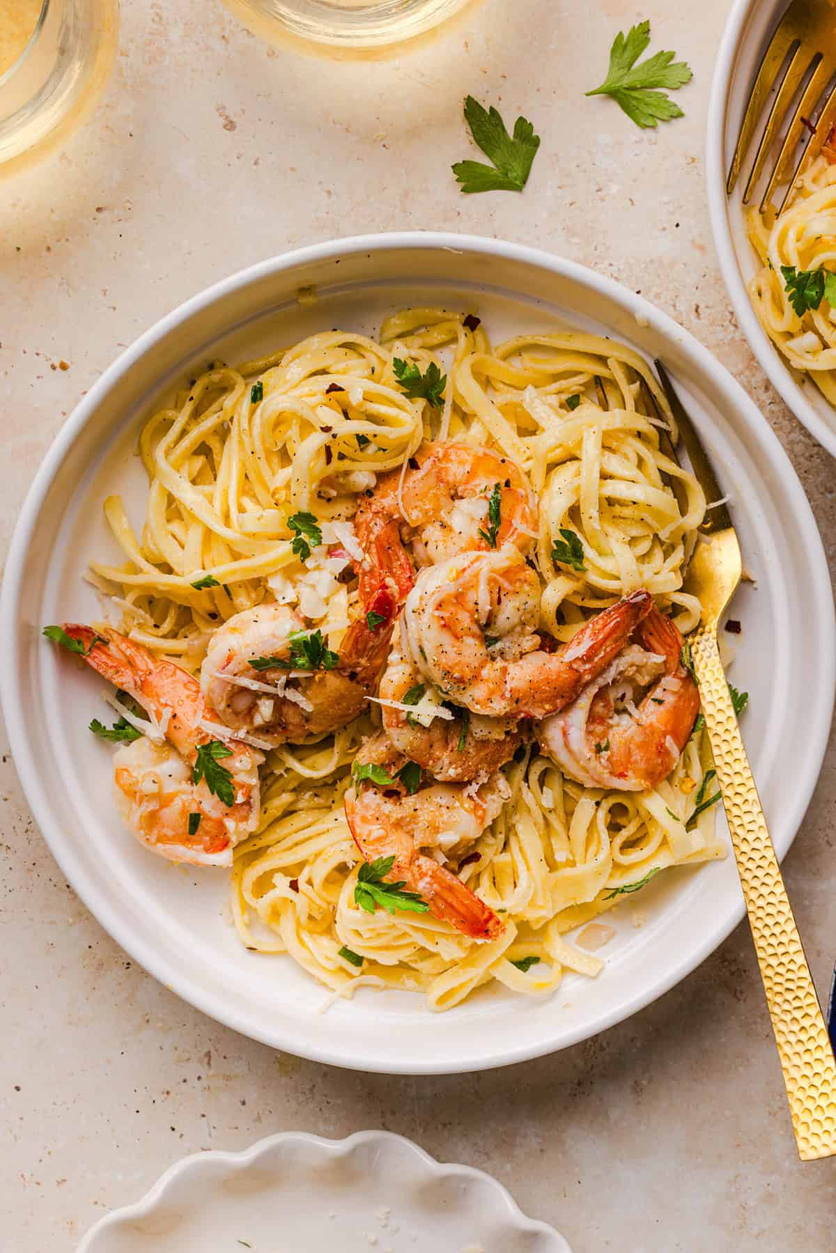 The BEST Healthy Shrimp Scampi recipe lightened up without sacrificing flavor! Juicy shrimp, garlic, lemon, white wine, and Parmesan are tossed with tender linguine in a silky, buttery sauce that’s ready in just 30 minutes.