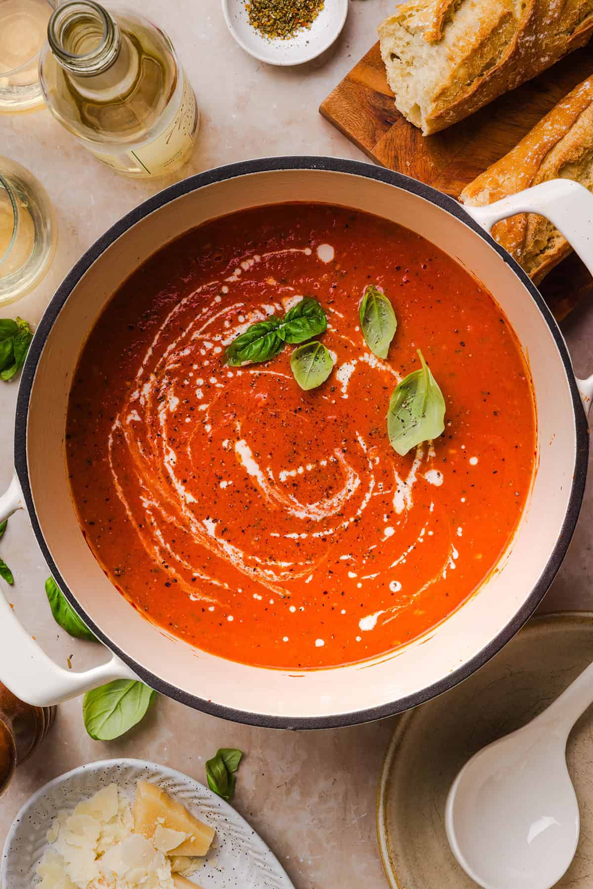A pot of creamy tomato basil soup simmering on the stove