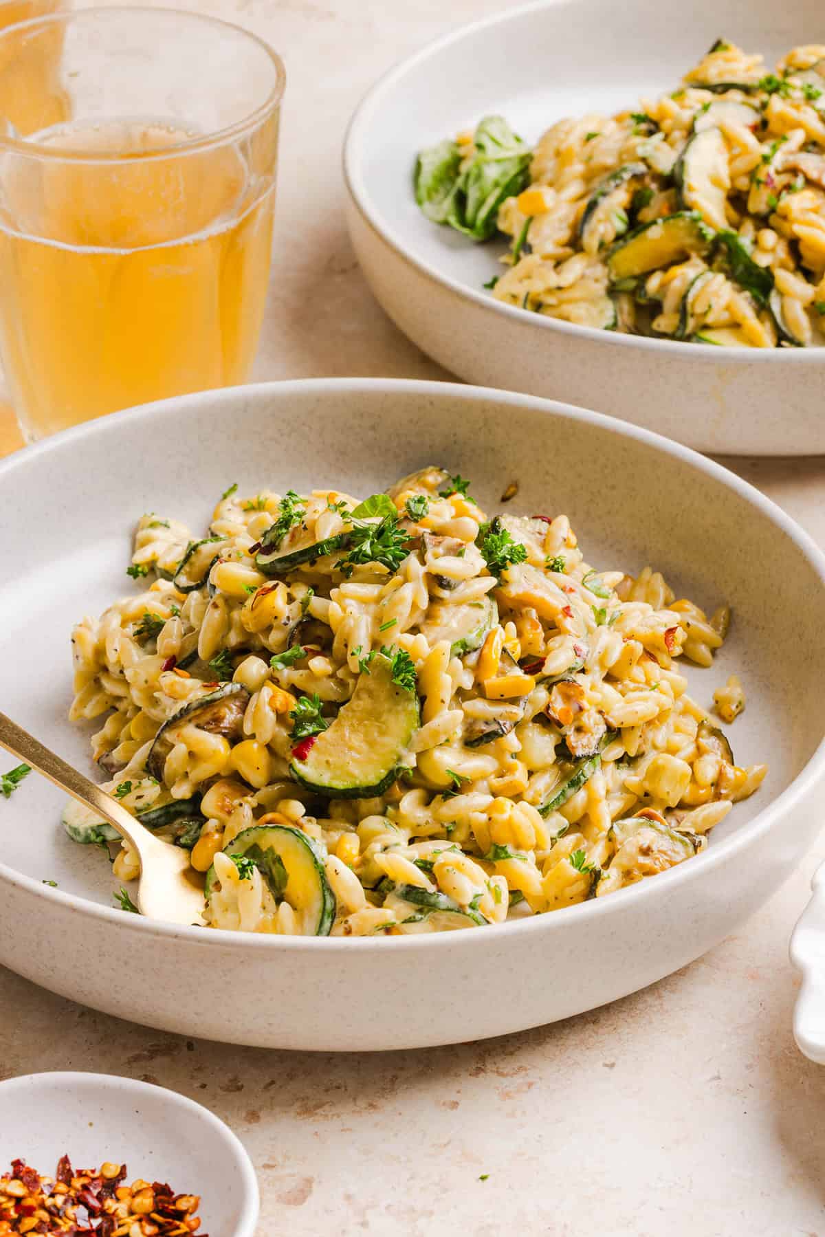 This creamy One Pan Lemon Garlic Orzo with Zucchini and Corn is fresh, flavorful and made in one skillet for an easy summer side dish or weeknight meal. Packed with fresh veggies, tender orzo, Parmesan, herbs and bright lemon flavor!
