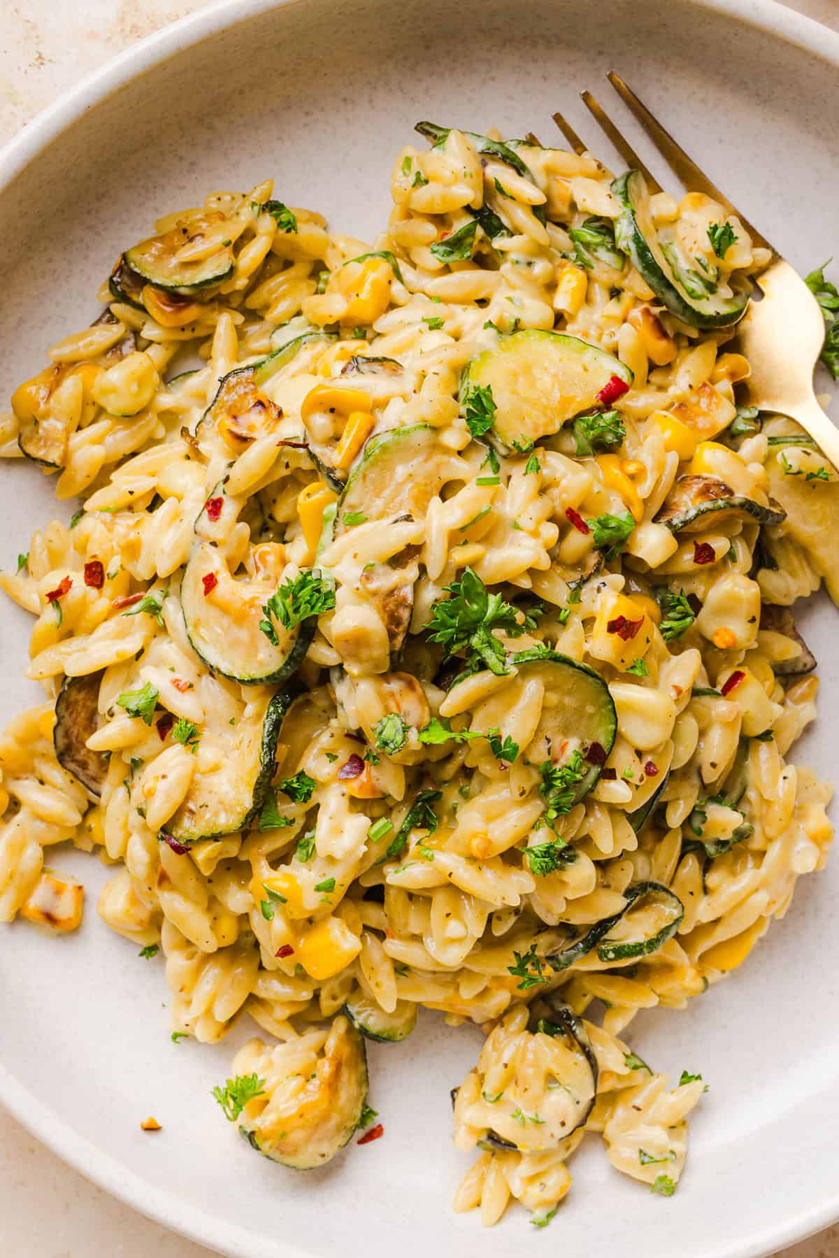 This creamy One Pan Lemon Garlic Orzo with Zucchini and Corn is fresh, flavorful and made in one skillet for an easy summer side dish or weeknight meal. Packed with fresh veggies, tender orzo, Parmesan, herbs and bright lemon flavor!