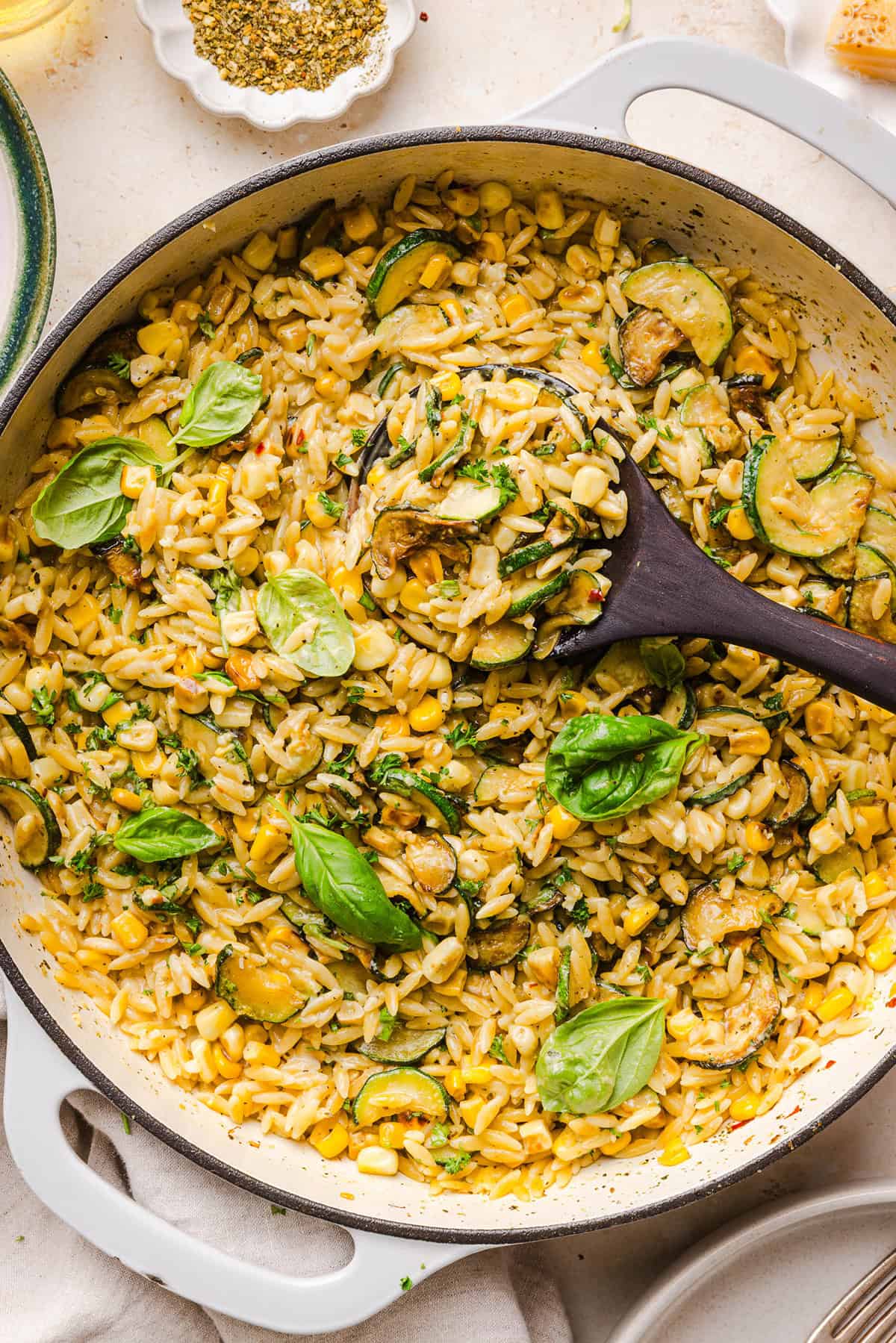 This creamy One Pan Lemon Garlic Orzo with Zucchini and Corn is fresh, flavorful and made in one skillet for an easy summer side dish or weeknight meal. Packed with fresh veggies, tender orzo, Parmesan, herbs and bright lemon flavor!
