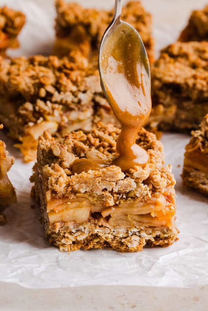 Healthy apple pie crumble bars drizzled with homemade salted caramel