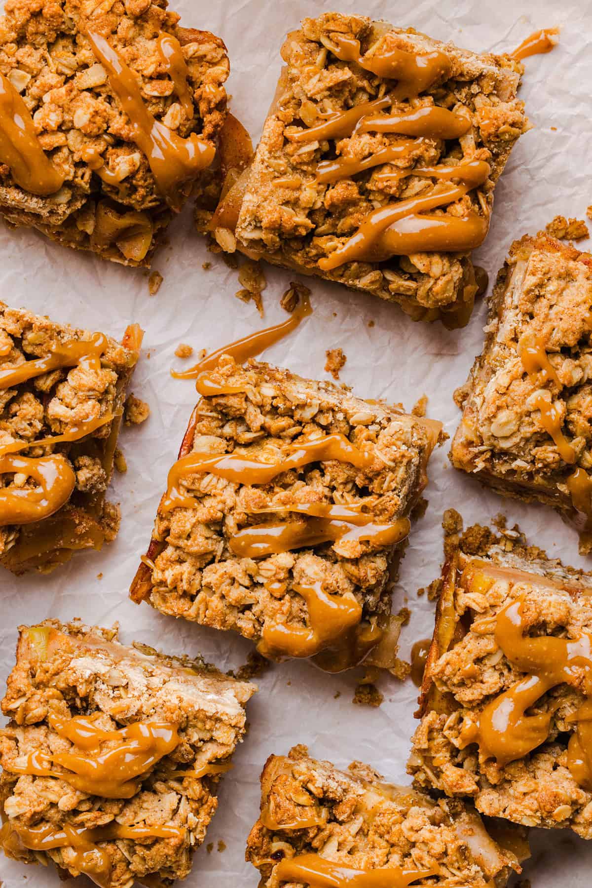 Apple pie crumble bars with a golden oat topping and maple caramel drizzle