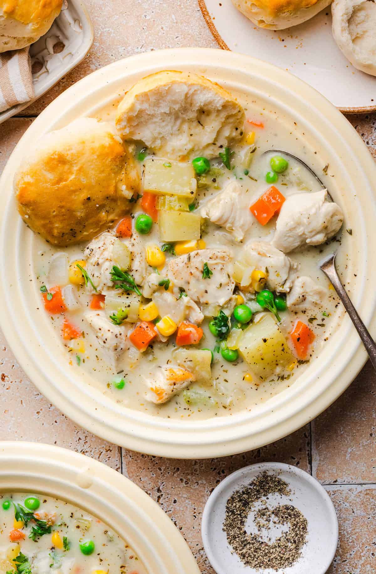 Healthy chicken pot pie soup with chicken, potatoes, carrots, peas and corn.